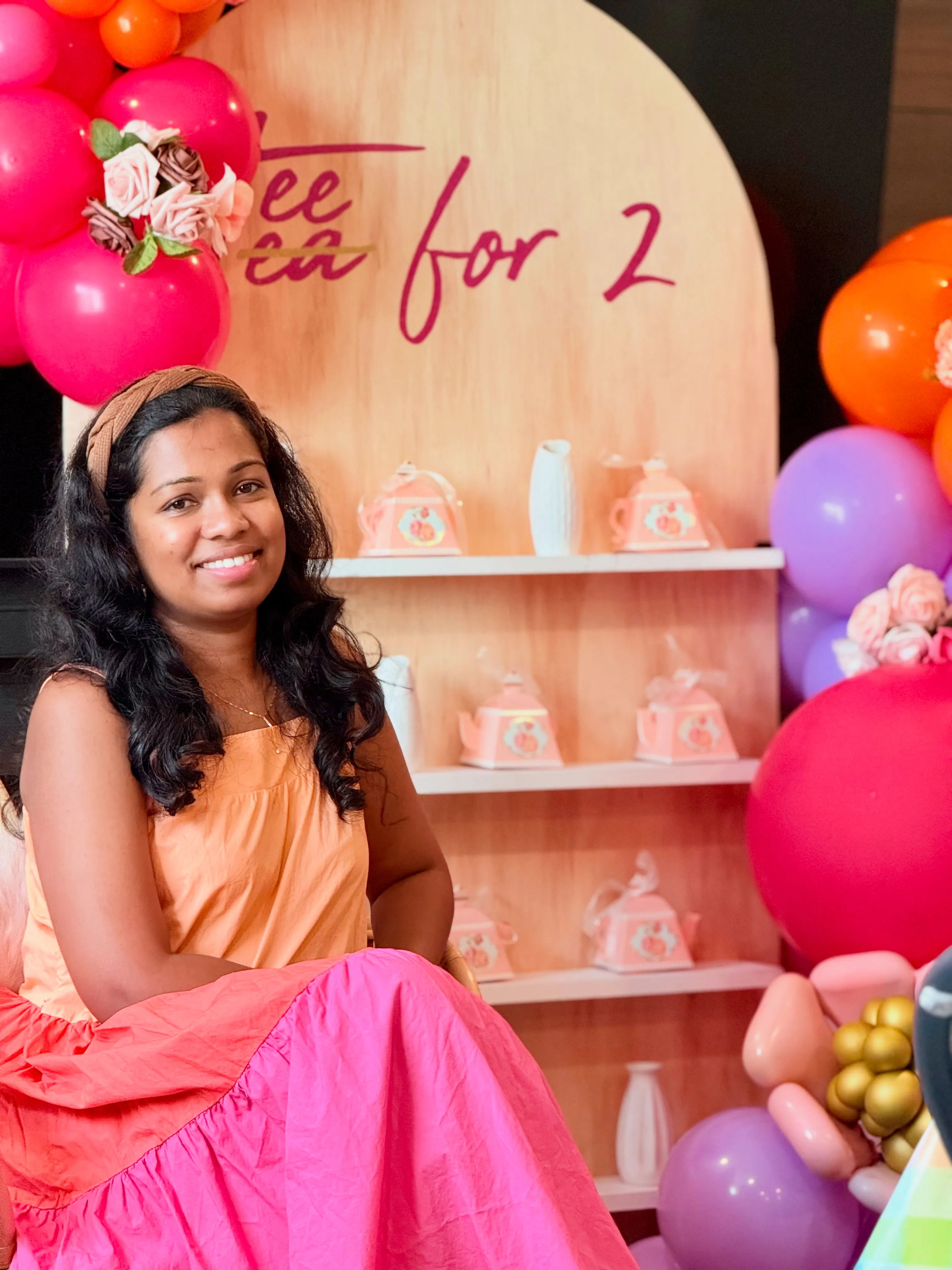 Ishara, owner of Party Perfect LLC, at a balloon-styled Tea for Two setup